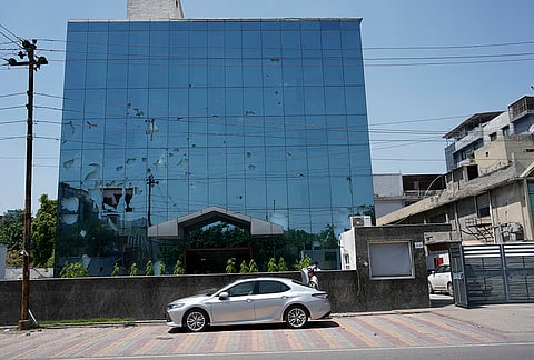 Broken facade of a factory building in Noida Sector 57 days after workers protests turned violent