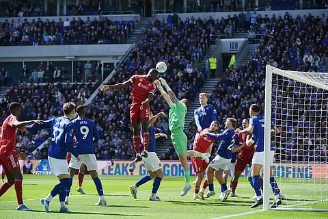 Liverpool's Ibrahima Konate, top, and Everton's goalkeeper Jordan Pickford compete for the ball during the English Premier League soccer match between Everton and Liverpool in Liverpool, England.