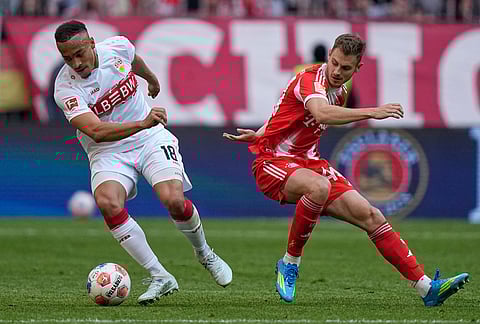 Stuttgart's Jamie Leweling, left, and Bayern's Josip Stanisic fight for the ball during a Bundesliga soccer match between Bayern and Stuttgart in Munich, Germany.