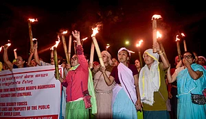 PTI : Women hold torches during a rally to protest against the recent bomb attack in which two children were killed, at Singjamei, in Imphal, Manipur