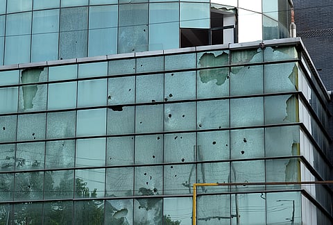 Broken facade of a factory building in Noida Sector 57 days after workers protests turned violent