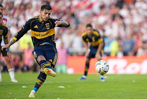 Boca Juniors' Leandro Paredes scores from the penalty spot his side's opening goal against River Plate during an Argentine soccer league match in Buenos Aires, Argentina.