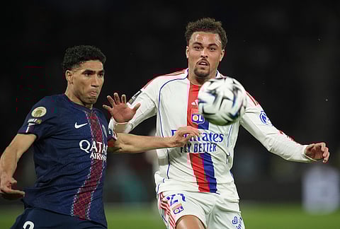 PSG's Achraf Hakimi, left, and Lyon's Ruben Kluivert challenge for the ball during the French League One soccer match between Paris Saint-Germain and Olympique Lyon in Paris, France.