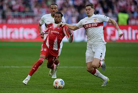 Bayern's Michael Olise, left, and Stuttgart's Ramon Hendriks fight for the ball during a Bundesliga soccer match between Bayern and Stuttgart in Munich, Germany.