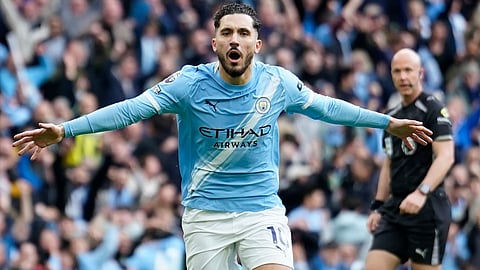 Manchester City's Rayan Cherki celebrates after scoring his side's first goal during the English Premier League soccer match between Manchester City and and Arsenal, in Manchester, England, Sunday, April 19, 2026. 