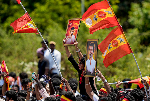 Tamilaga Vettri Kazhagam (TVK) supporters gather during a roadshow led by party chief and candidate from the Tiruchirappalli East constituency, Vijay, ahead of the Tamil Nadu Assembly elections, in Tiruvallur.