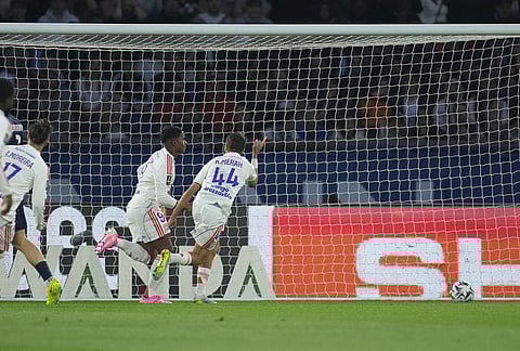 Lyon's Endrick, second from right, celebrates after scoring the opening goal during the French League One soccer match between Paris Saint-Germain and Olympique Lyon in Paris, France.