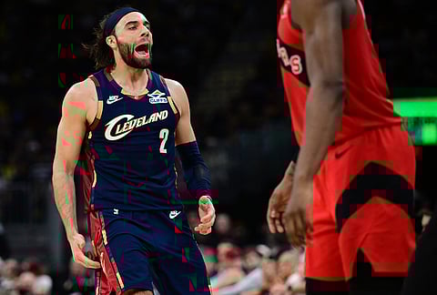 Cleveland Cavaliers guard Max Strus reacts after a three-point basket against the Toronto Raptors during the second half in Game 1 of a first-round NBA playoffs basketball series, in Cleveland.