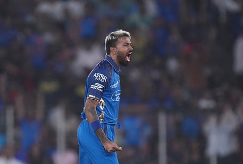 Mumbai Indians' captain Hardik Pandya celebrates the wicket of Gujarat Titans' Jos Buttler during the Indian Premier League cricket match between Gujarat Titans and Mumbai Indians in Ahmedabad.