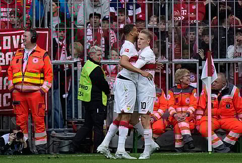 Stuttgart's Josha Vagnoman, left, and Chris Fuehrich celebrate after scoring during a Bundesliga soccer match between Bayern and Stuttgart in Munich, Germany.