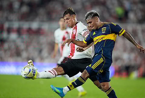 River Plate's Joaquin Freitas, left, and Boca Juniors' Milton Delgado vie for the ball during an Argentine soccer league match in Buenos Aires, Argentina.