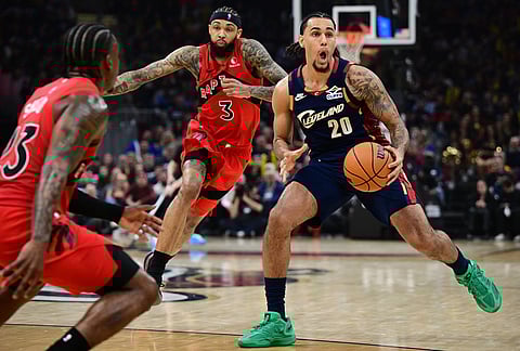Cleveland Cavaliers guard Jaylon Tyson looks to pass while being guarded by Toronto Raptors guard Jamal Shead, front and forward Brandon Ingram (3) during the second half in Game 1 of a first-round NBA playoffs basketball series, in Cleveland.