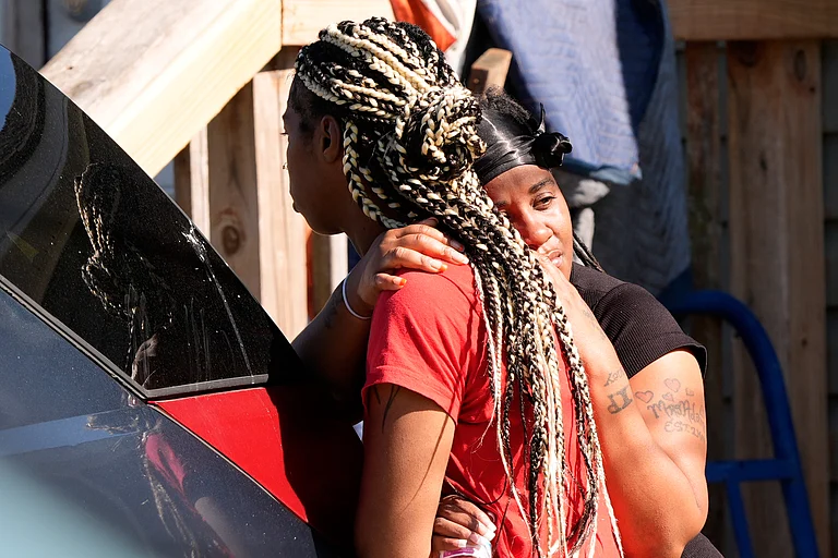People grieve outside the scene of a mass shooting, Sunday, April 19, 2026, in Shreveport, La. (AP Photo/Gerald Herbert) - Source: AP