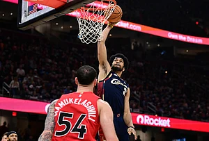 | Photo: AP/David Dermer : Cleveland Cavaliers center Jarrett Allen dunks over Toronto Raptors forward Sandro Mamukelashvili during the second half in Game 1 of a first-round NBA playoffs basketball series in Cleveland.