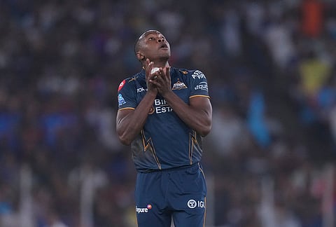 Gujarat Titans' Kagiso Rabada takes the catch to dismiss Mumbai Indian's Quinton de Kock during the Indian Premier League cricket match between Gujarat Titans and Mumbai Indians in Ahmedabad.