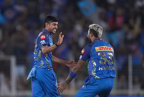 Mumbai Indians' Ashwani Kumar, left, and Mumbai Indians' captain Hardik Pandya celebrates the wicket of Gujarat Titans' captain Shubman Gill during the Indian Premier League cricket match between Gujarat Titans and Mumbai Indians in Ahmedabad.
