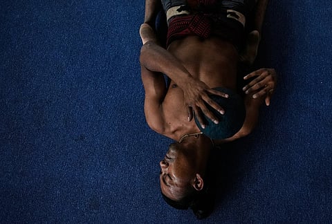 A player stretches prior to a match during an ulama championship, a traditional ballgame with roots in Mesoamerican culture, in Mexico City.