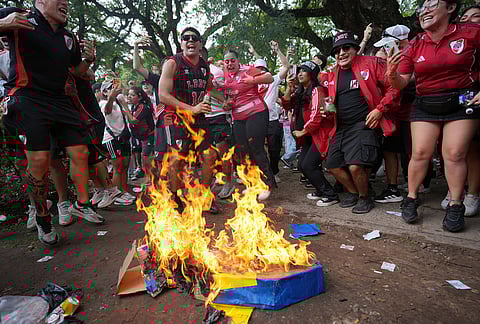 River Plate fans burn a Boca Juniors' emblem prior to an Argentine league match between River Plate and Boca Juniors in Buenos Aires, Argentina.