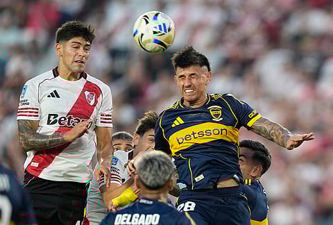 River Plate's Lautaro Rivero, left, and Boca Juniors' Adam Bareiro go for a header during an Argentine soccer league match in Buenos Aires, Argentina.