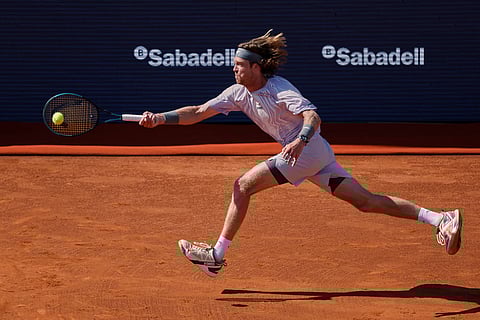 Russia's Andrey Rublev returns the ball to France's Arthur Fils during the ATP Barcelona Open tennis final in Barcelona, Spain.