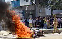 Noida Workers Protest: Is Protest Against “Normal”? Source: PTI : Flames billow as a police bike is set ablaze by factory workers during a protest demanding a hike in wages, in Noida, Gautam Buddh Nagar district, Uttar Pradesh, Monday, April 13, 2026. The protest carried incidents of arson, vandalism and stone-pelting reported from Phase-2 and Sector 60 areas, police said.