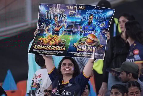 A fan holds a poster during the Indian Premier League cricket match between Gujarat Titans and Mumbai Indians in Ahmedabad.