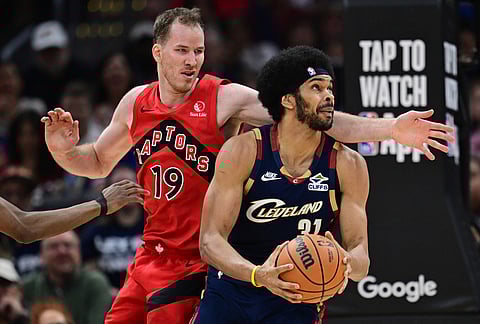 Cleveland Cavaliers center Jarrett Allen goes to the basket against Toronto Raptors center Jakob Poeltl during the first half in Game 1 of a first-round NBA playoffs basketball series, in Cleveland.