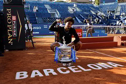 France's Arthur Fils poses with the trophy after defeating Russia's Andrey Rublev during the ATP Barcelona Open tennis final in Barcelona, Spain.