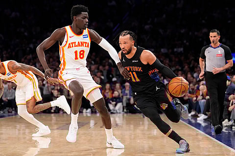 New York Knicks guard Jalen Brunson (11) drives past Atlanta Hawks forward Mouhamed Gueye (18) during the first half in Game 2 of a first-round NBA playoffs basketball series in New York.
