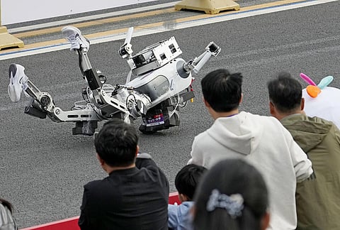 A humanoid robot falls right after the start of a half-marathon race for robots in Beijing.
