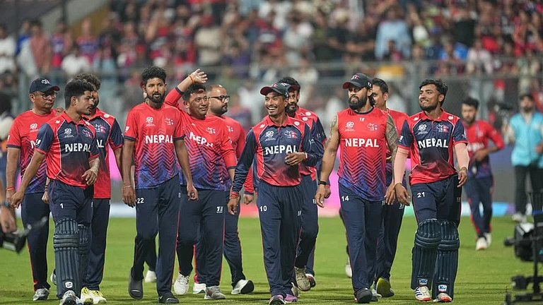 Nepal cricket team walks back to the pavilion after defeating Scotland during the T20 World Cup cricket match in Mumbai. - | Photo: AP/Rafiq Maqbool