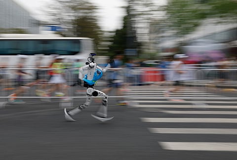 A humanoid robot runs in the second Beijing E-Town Half Marathon and Humanoid Robot Half Marathon in Beijing. 