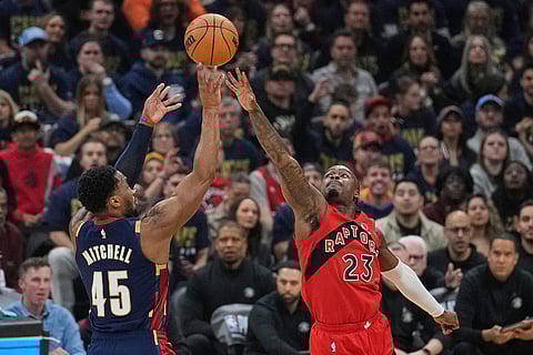 Cleveland Cavaliers guard Donovan Mitchell (45) shoots over Toronto Raptors guard Jamal Shead (23) in the first half in Game 2 of a first-round NBA basketball playoffs series in Cleveland.