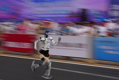 A robot starts off for the Beijing E-Town Half Marathon and Humanoid Half Marathon held on the outskirts of Beijing.