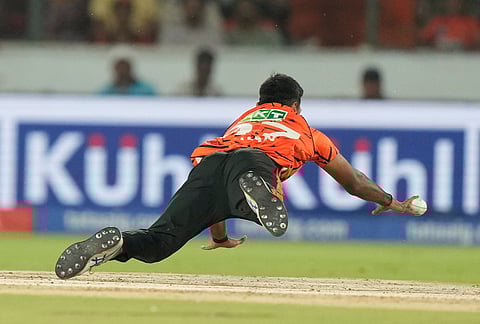 Sunrisers Hyderabad's Eshan Malinga dives to catch during the Indian Premier League cricket match between Sunrisers Hyderabad and Delhi Capitals in Hyderabad.