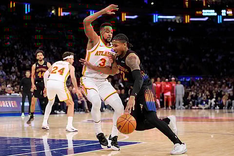 New York Knicks guard Miles McBride (2) drives past Atlanta Hawks guard CJ McCollum (3) during the first half in Game 2 of a first-round NBA playoffs basketball series in New York.