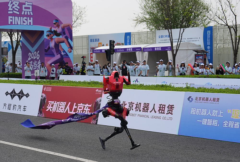 A robot tagged along a ribbon as it crossing the finish line in the Beijing E-Town Half Marathon and Humanoid Robot Half-Marathon on the outskirts of Beijing. - | Photo: AP/Andy Wong