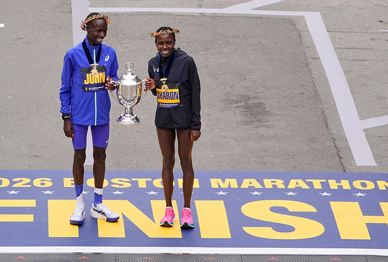 Boston Marathon winner John Korir of Kenya, left, holds the trophy with women's division winner Sharon Lokedi, also of Kenya, at the finish line of the Boston Marathon, in Boston. - | Photo: AP/Charles Krupa