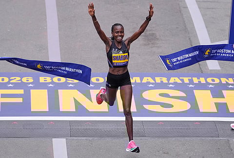 Sharon Lokedi of Kenya, celebrates after winning the women's division of the Boston Marathon, in Boston.