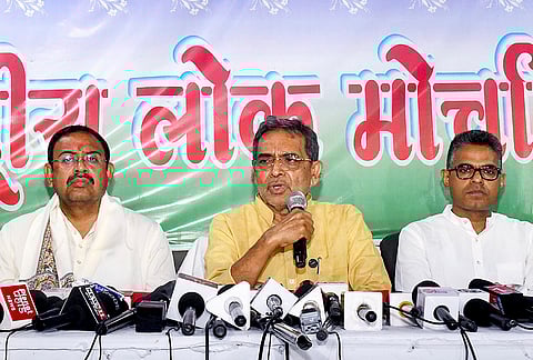 Rashtriya Lok Morcha chief Upendra Kushwaha, centre, addresses a press conference, in Patna.
