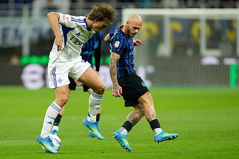 Como's Nico Paz, left, and Inter Milan's Federico Dimarco challenge for the ball during the Italian Cup, return-leg soccer match between Inter Milan and Como, in Milan, Italy.