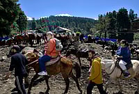 One Year After Pahalgam: The Long Road Back for Tourism | Photo: Yasir Iqbal : Tourists enjoy a horse ride through the scenic trails of Pahalgam. A year after the attacks, the region’s tourism revival is slowly gaining momentum, bringing a sense of hope back to the local community.