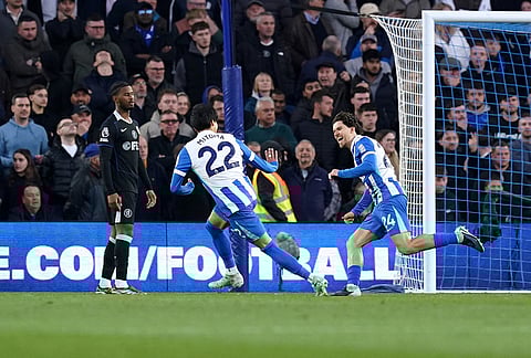 Brighton and Hove Albion's Ferdi Kadioglu, right, celebrates scoring their side's first goal during the English Premier League soccer match between Brighton & Hove Albion and Chelsea in Brighton, England.