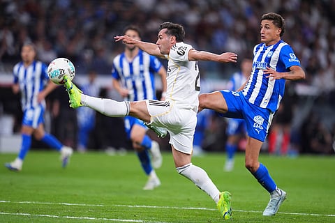 Real Madrid's Brahim Diaz , left, and Alaves' Nahuel Tenaglia fight for the ball during a La Liga soccer match between Real Madrid and Alaves in Madrid, Spain.
