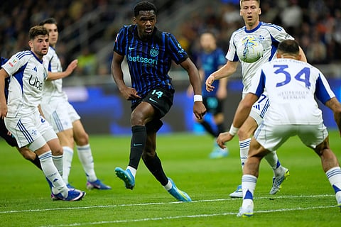 Inter Milan's Ange-Yoan Bonny, center, controls the ball during the Italian Cup, return-leg soccer match between Inter Milan and Como, in Milan, Italy.