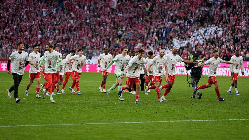 Bayern Munich players celebrate after their team clinched the German league title after a Bundesliga match against Stuttgart in Munich. - Matthias Schrader