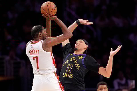 Houston Rockets forward Kevin Durant, left, shoots as Los Angeles Lakers center Jaxson Hayes defends during the second half in Game 2 of a first-round NBA playoffs basketball series in Los Angeles.