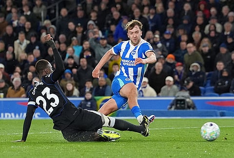 Brighton and Hove Albion's Jack Hinshelwood, right, scores their second goal during the Premier League soccer match between Brighton and Hove Albion and Chelsea, in Brighton, England.