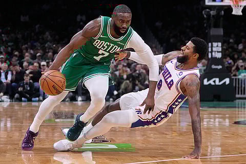 Boston Celtics guard Jaylen Brown (7) drives to the basket against Philadelphia 76ers forward Paul George (8) during the first half of Game 2 of a first-round NBA playoffs basketball series in Boston.