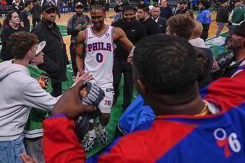 Philadelphia 76ers guard Tyrese Maxey (0) is congratulated by fans after defeating the Boston Celtics following Game 2 of a first-round NBA playoffs basketball series in Boston.